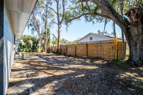 a view of a large house with a tree in front of it