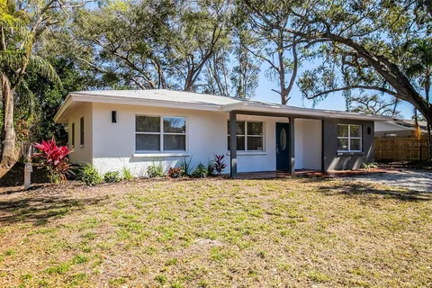 a house that has a tree in front of it