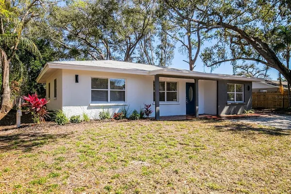 a house that has a tree in front of it