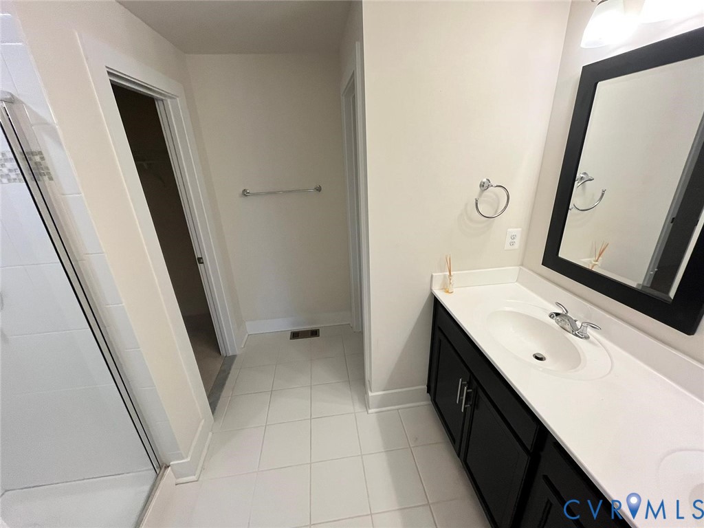 4324 Bon Secours Parkway, Unit A Henrico, VA 23233 - Photo 13 of 19 Bathroom with double vanity, a shower stall, light
