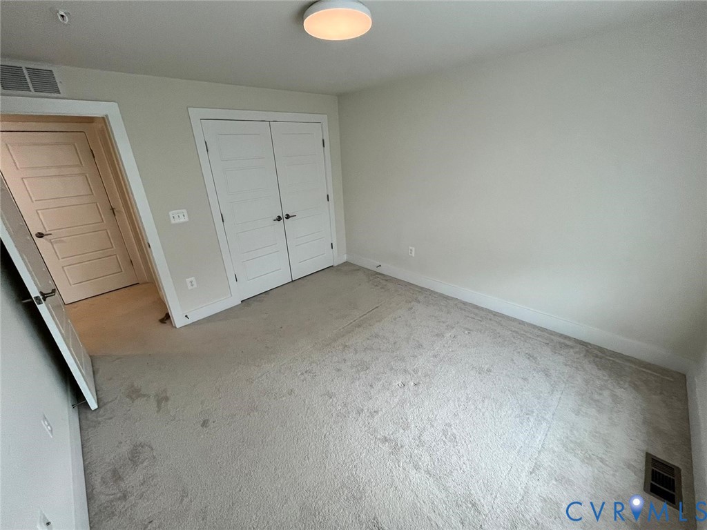 4324 Bon Secours Parkway, Unit A Henrico, VA 23233 - Photo 17 of 19 Unfurnished bedroom featuring a closet and carpet