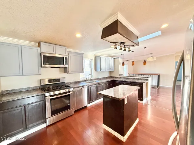 a view of an empty room with a window and a chandelier
