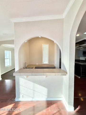 a kitchen with granite countertop a stove and a sink