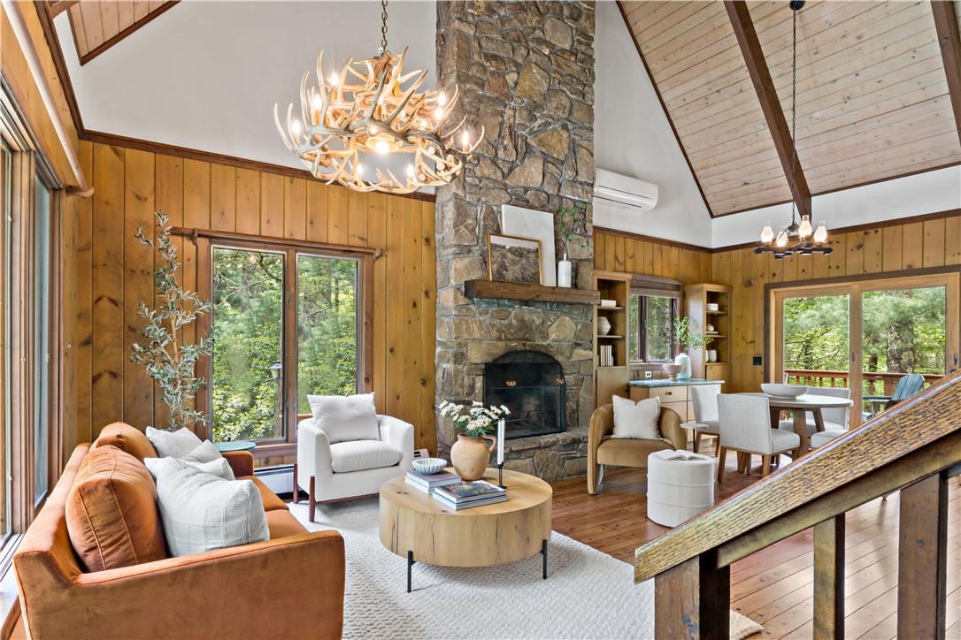 310 Old Coach Road Charlestown, RI 02813 - Photo 1 of 45 Bring the outdoors indoors in the main living space of this rustic cabin among the pines. The floor to ceiling wood burning fireplace stones were hand placed by a local Indian tribe for the original owner.