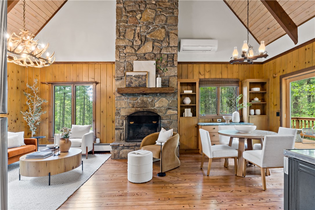 310 Old Coach Road Charlestown, RI 02813 - Photo 2 of 45 Hardwood floors, cathedral ceilings, wood burning fireplace and sliders to outdoor deck are just some of the features in this living space.