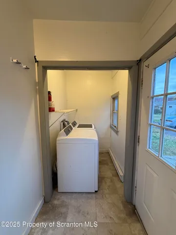 a view of bathroom with a tub and mirror