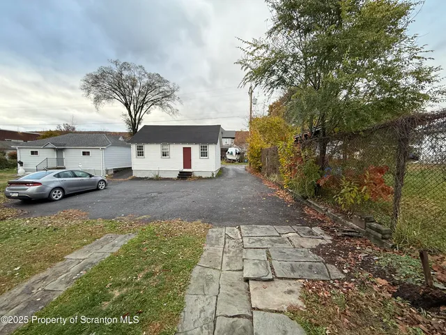 a street view with couple of cars parked on road