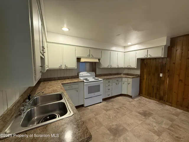 a kitchen with a sink cabinets and stainless steel appliances