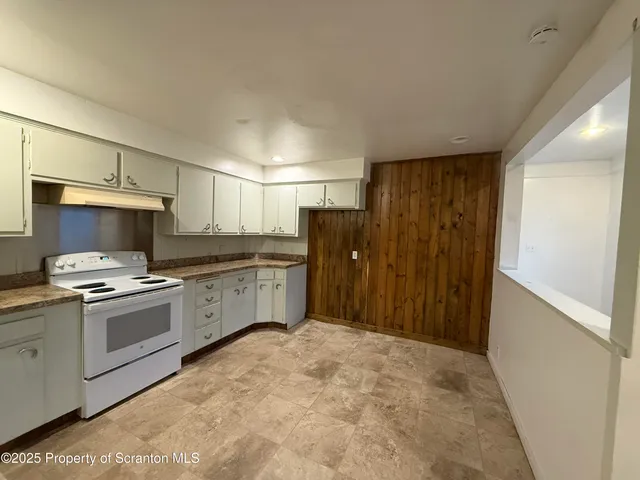 a kitchen with a stove top oven and sink