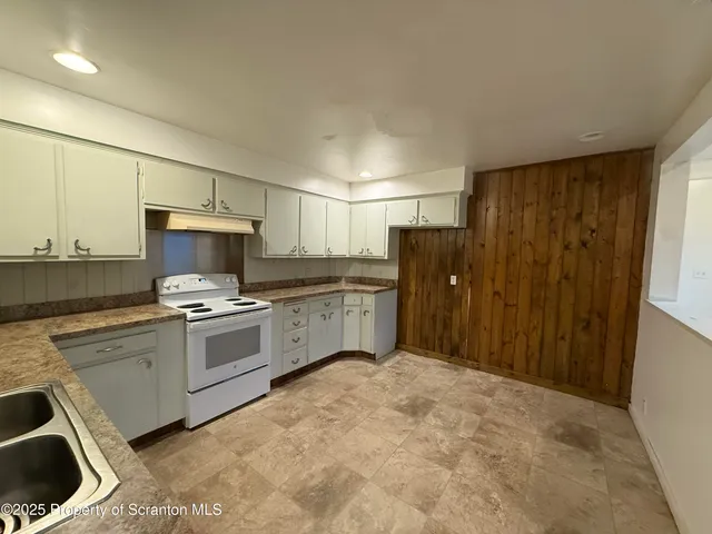 a kitchen with a sink and a stove top oven
