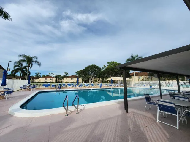 a view of a swimming pool with seating space