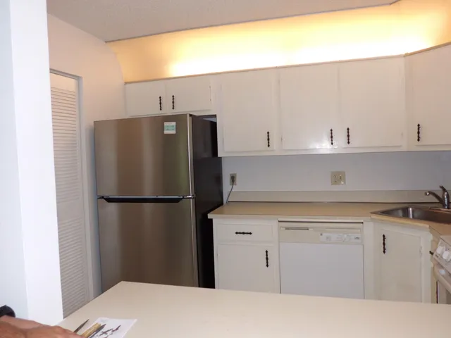 a kitchen with a refrigerator and cabinets