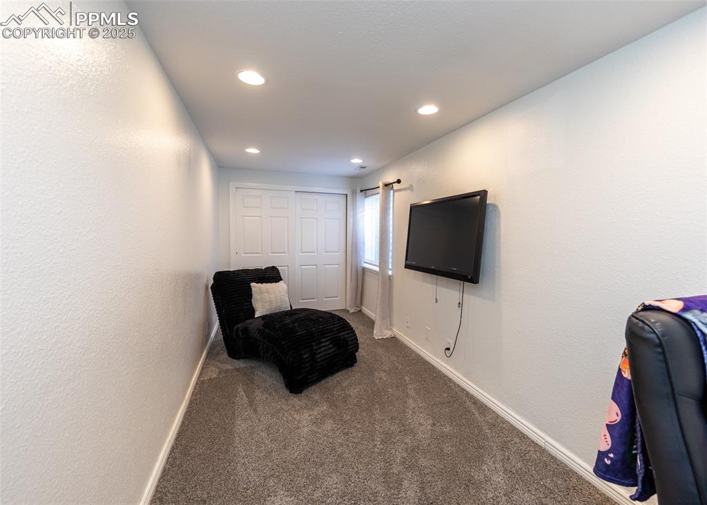 7751 Tompkins Road Peyton, CO 80831 - Photo 11 of 26 a living room with furniture and a flat screen tv
