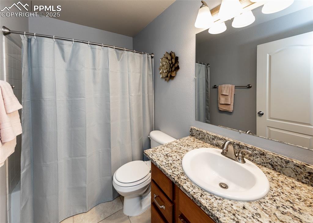 7751 Tompkins Road Peyton, CO 80831 - Photo 12 of 26 a bathroom with a granite countertop sink and a mirror