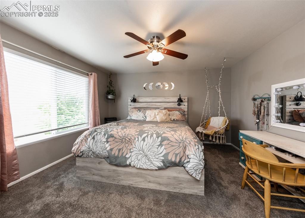 7751 Tompkins Road Peyton, CO 80831 - Photo 13 of 26 a bedroom with a bed and window