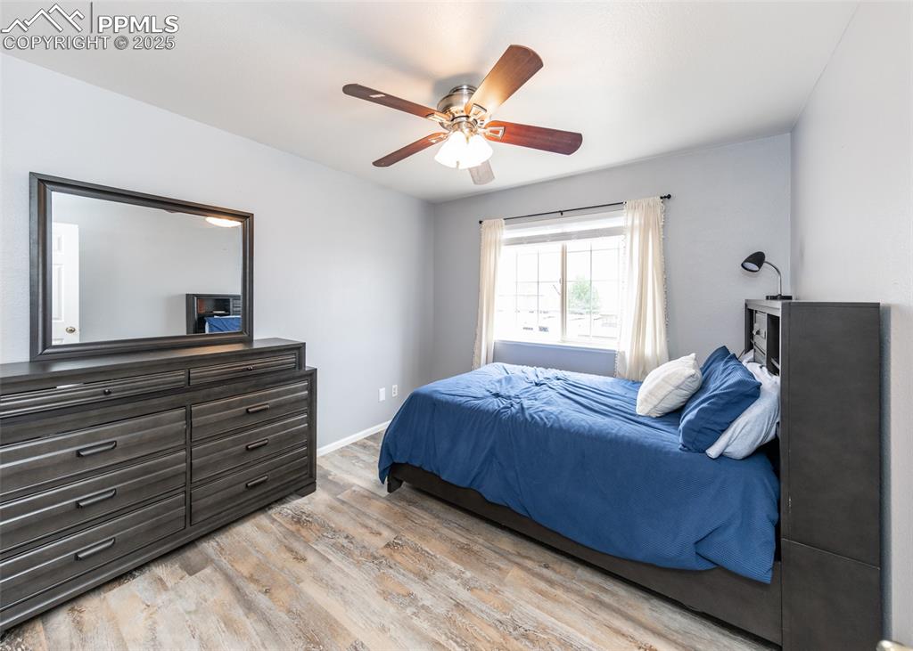 7751 Tompkins Road Peyton, CO 80831 - Photo 16 of 26 a bedroom with a bed and a large mirror on the dresser
