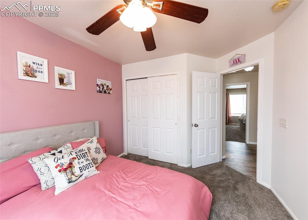 7751 Tompkins Road Peyton, CO 80831 - Photo 17 of 26 a bedroom with a bed and a walk in closet