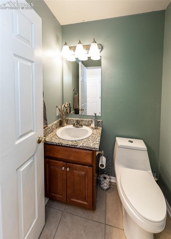 7751 Tompkins Road Peyton, CO 80831 - Photo 19 of 26 a bathroom with a toilet sink and mirror