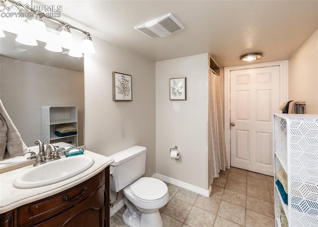 7751 Tompkins Road Peyton, CO 80831 - Photo 10 of 26 a bathroom with a sink toilet and shower
