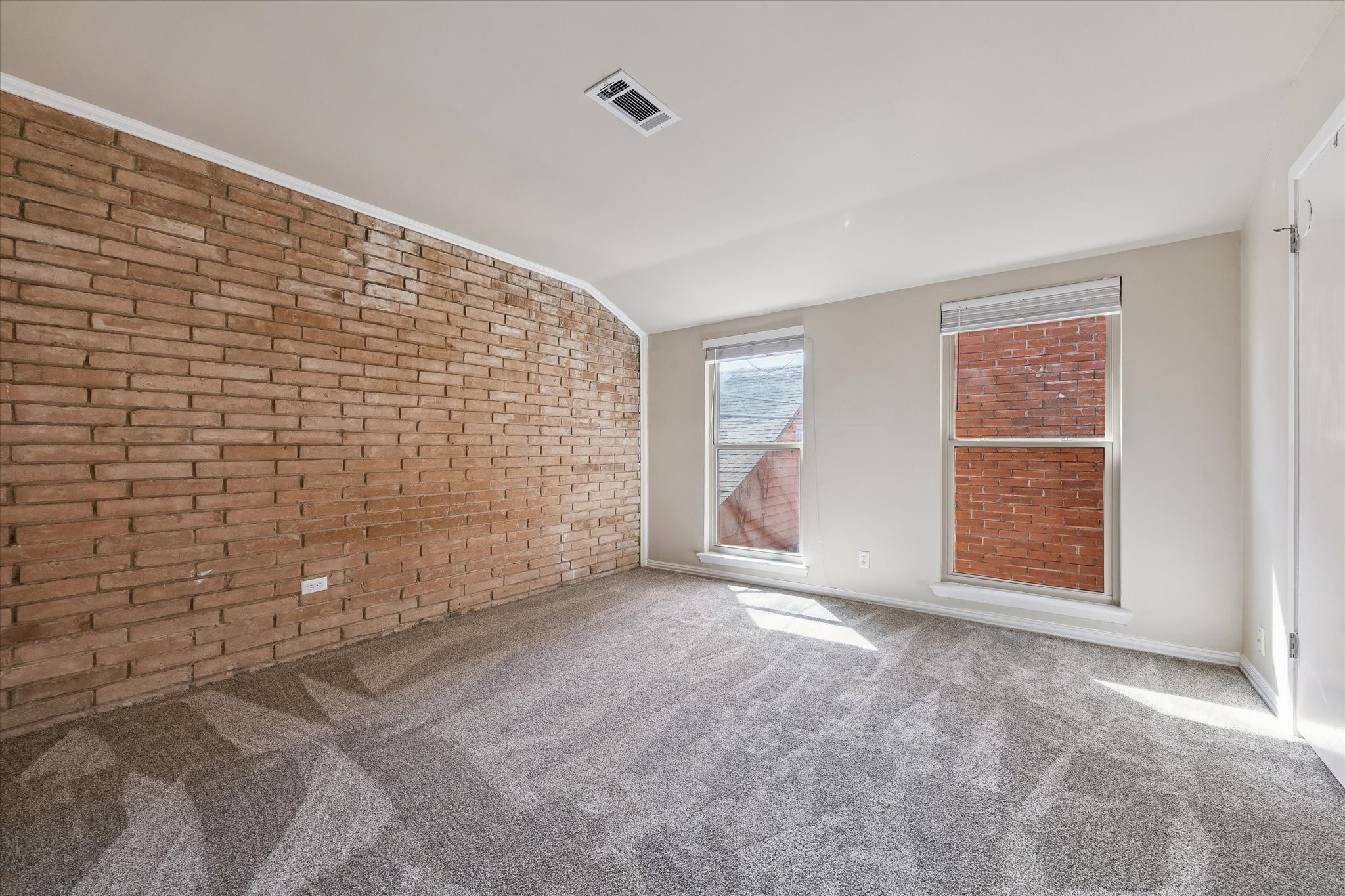1205 Autrey Street, Unit 9 Houston, TX 77006 - Photo 9 of 32 Second bedroom with new carpeting, natural light and brick wall.