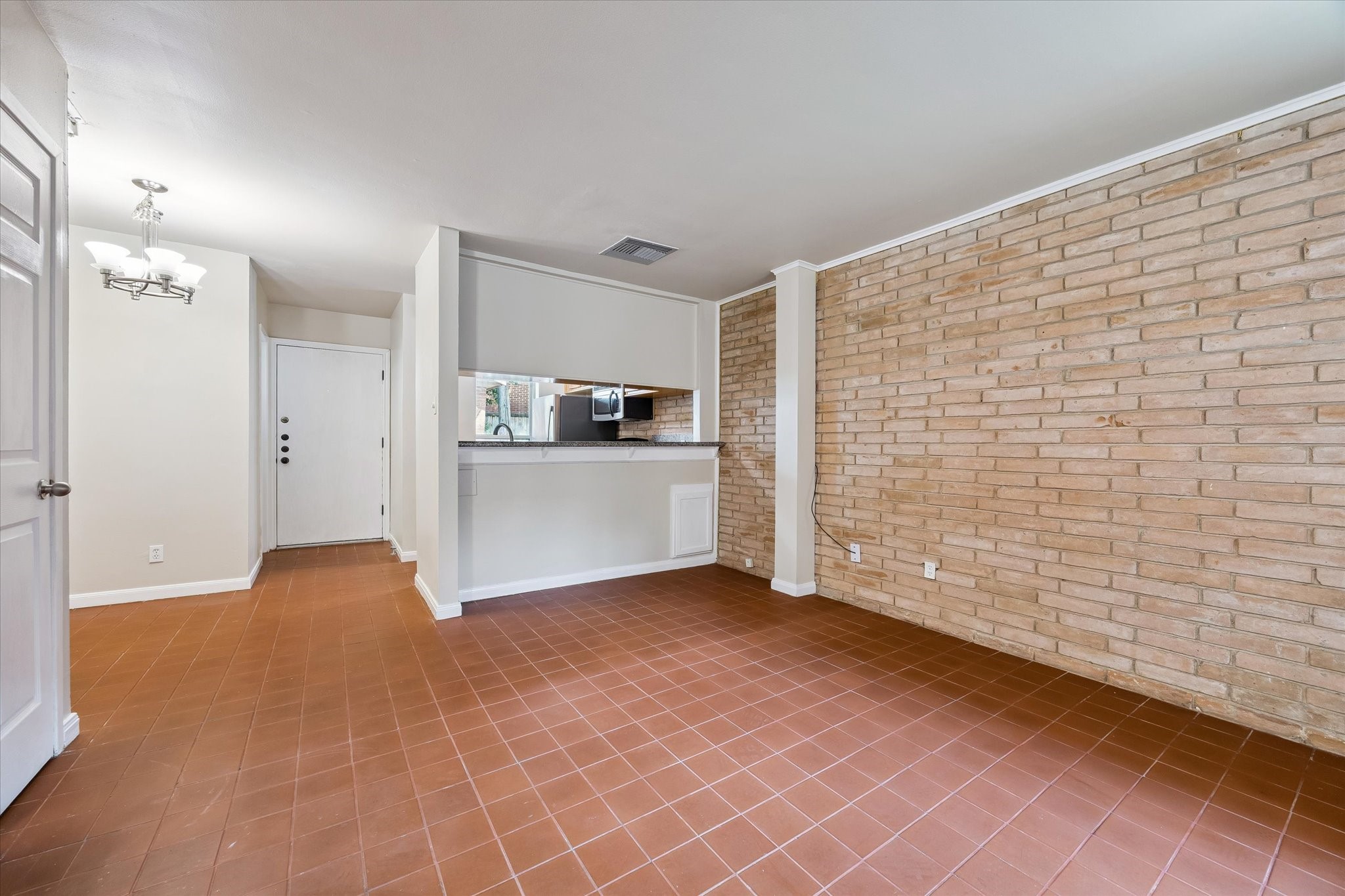 1205 Autrey Street, Unit 9 Houston, TX 77006 - Photo 10 of 32 Living room with tile and brick wall.