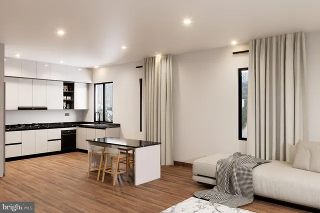 a large living room with stainless steel appliances kitchen island granite countertop furniture and a wooden floor