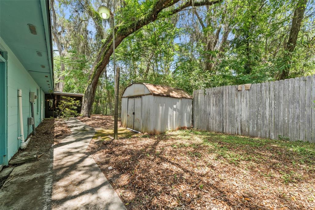 4825 Southwest 19th Street Gainesville, FL 32608 - Photo 28 of 40 a view of a backyard with wooden fence
