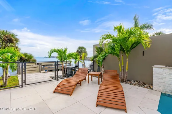a view of a swimming pool with outdoor seating
