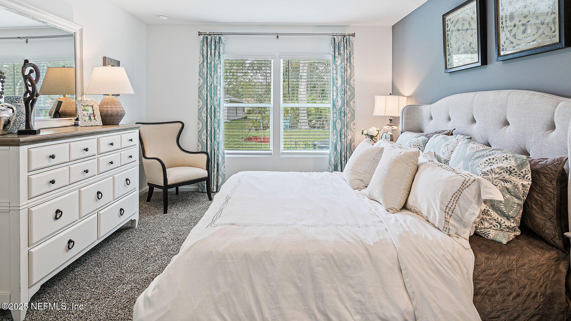 31 Palm Lane Palm Coast, FL 32164 - Photo 13 of 34 a large bed sitting in a bedroom next to a window with lamp