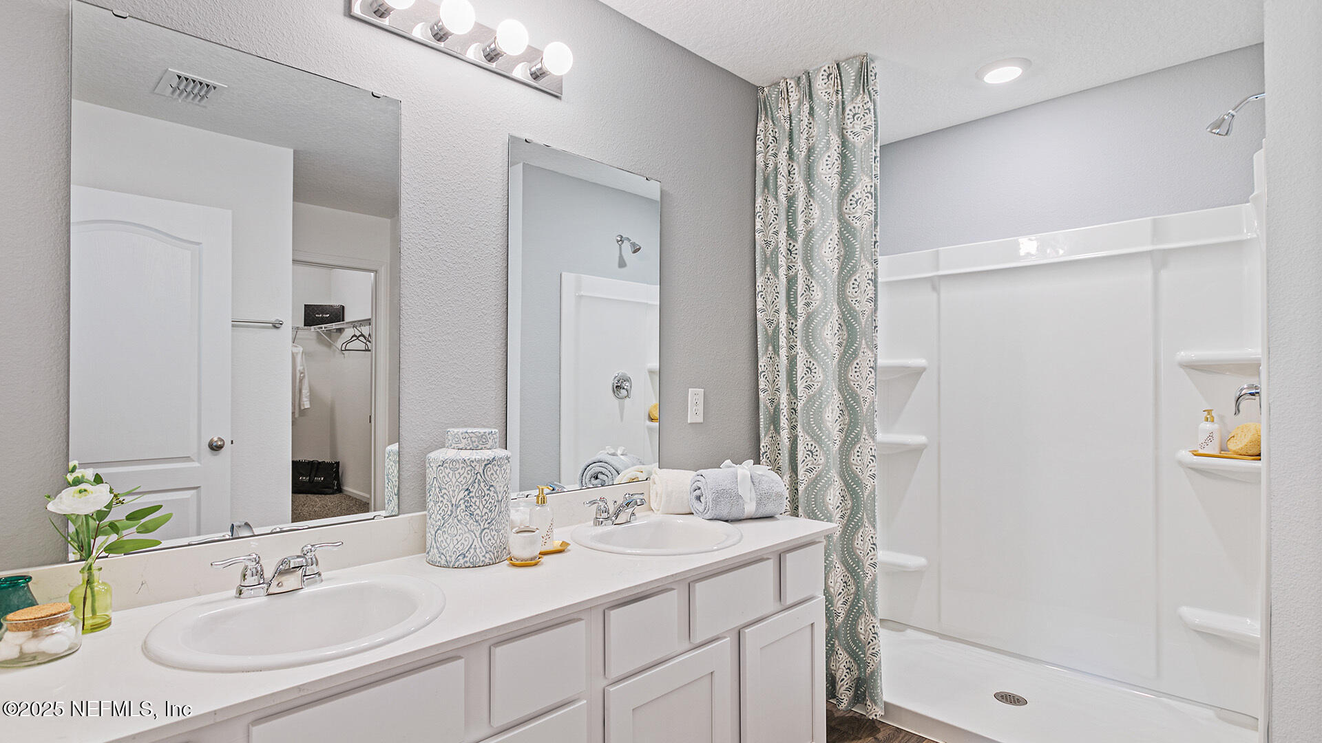 31 Palm Lane Palm Coast, FL 32164 - Photo 15 of 34 a bathroom with a shower sink vanity and mirror