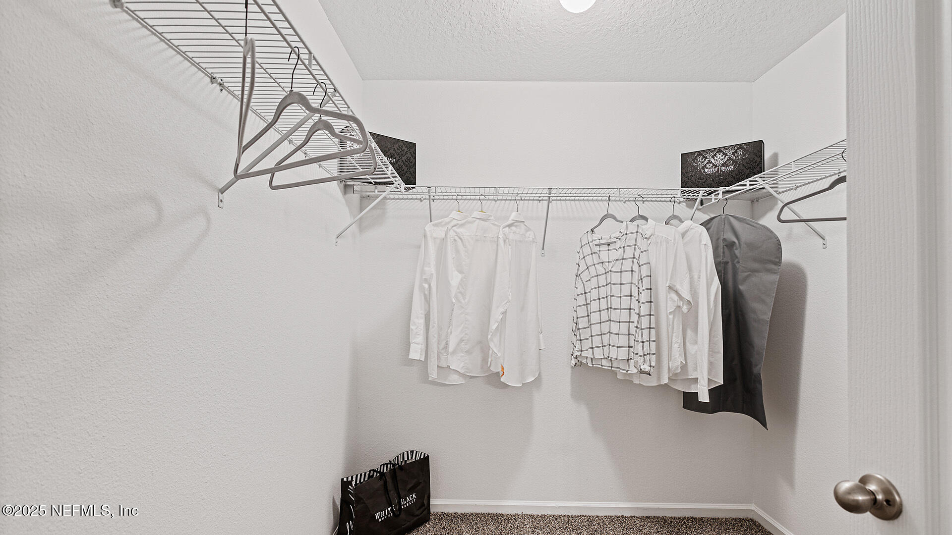 31 Palm Lane Palm Coast, FL 32164 - Photo 17 of 34 a view of walk in closet with clothes
