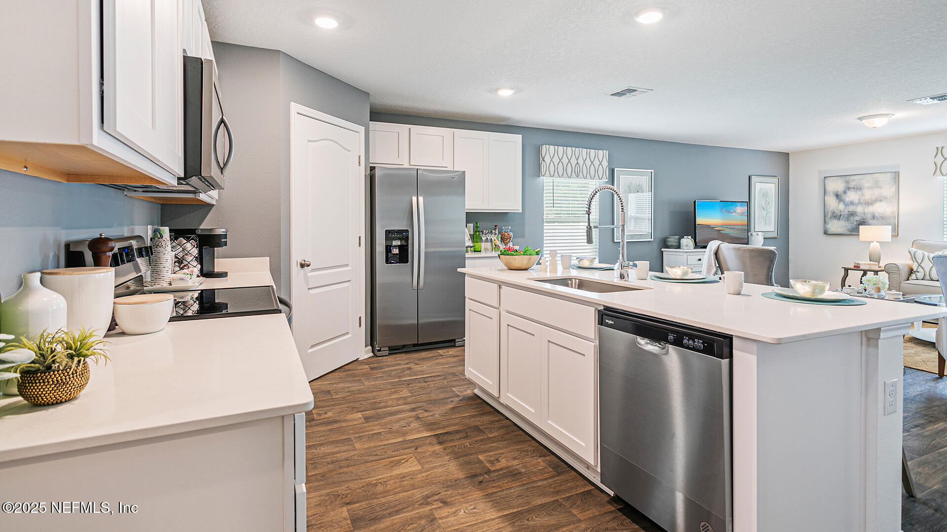 31 Palm Lane Palm Coast, FL 32164 - Photo 4 of 34 a kitchen with kitchen island a sink appliances and cabinets