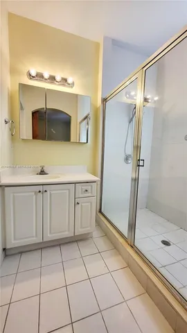 a bathroom with a shower and a mirror
