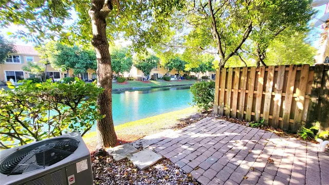 a view of a backyard with plants and lake view
