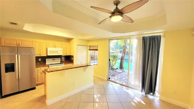 a kitchen with stainless steel appliances granite countertop a refrigerator a stove and a sink with granite countertops