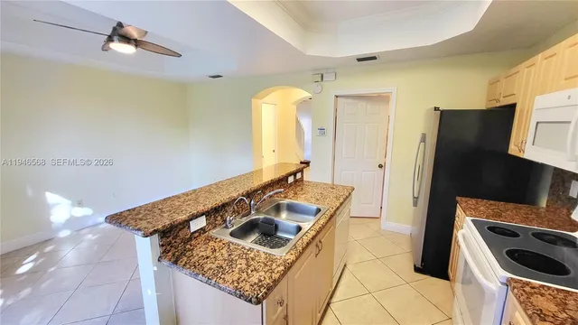 a kitchen with a stove a refrigerator and a sink
