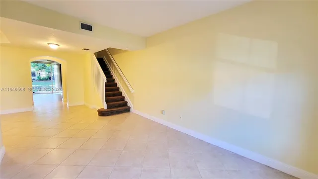 a view of an empty room with stairs