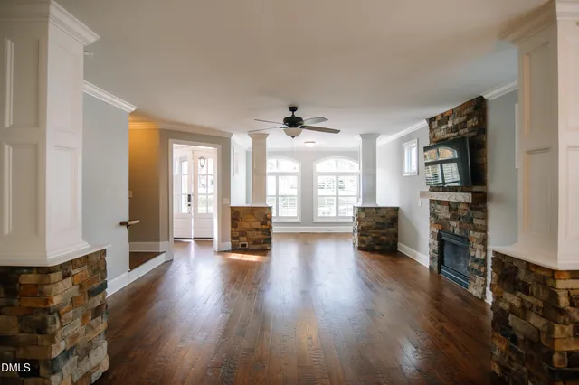 a view of a living room with furniture and wooden floor