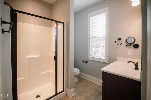 a bathroom with a shower sink and toilet