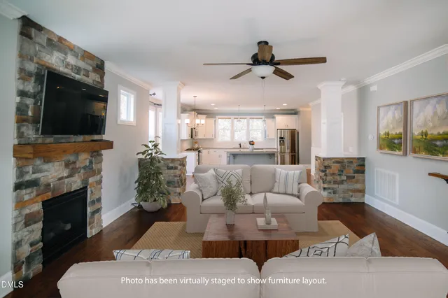 a living room with furniture a fireplace and a flat screen tv