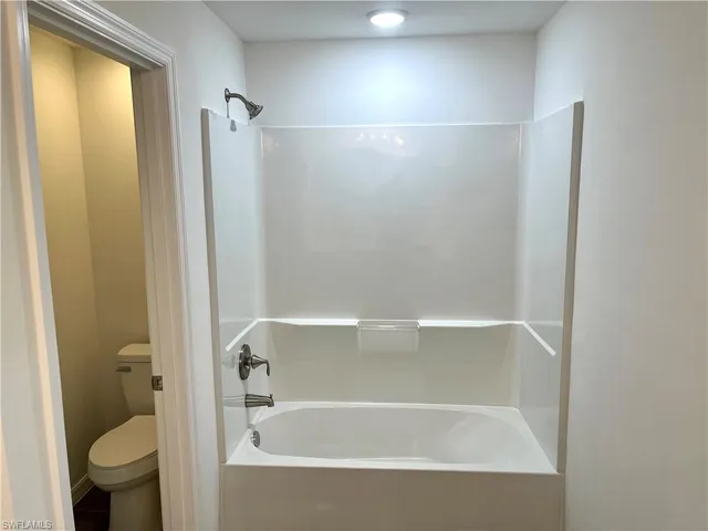 a bathroom with a bathtub and a toilet