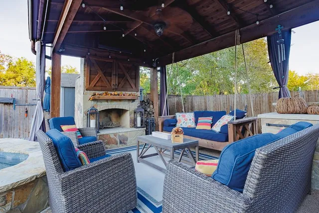 a outdoor space with patio the couches and a fireplace