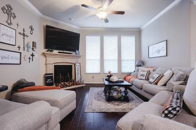 a living room with furniture a fireplace and a flat screen tv