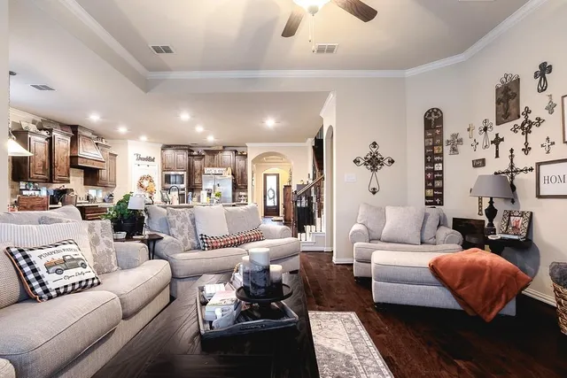 a living room with furniture wooden floor and a large window