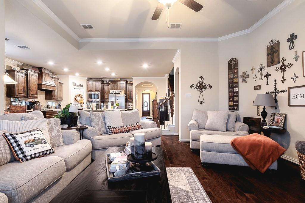 4505 Evenstar Way Plano, TX 75074 - Photo 14 of 29 Living area featuring dark wood-style flooring, ornamental molding, a ceiling fan, and recessed lighting