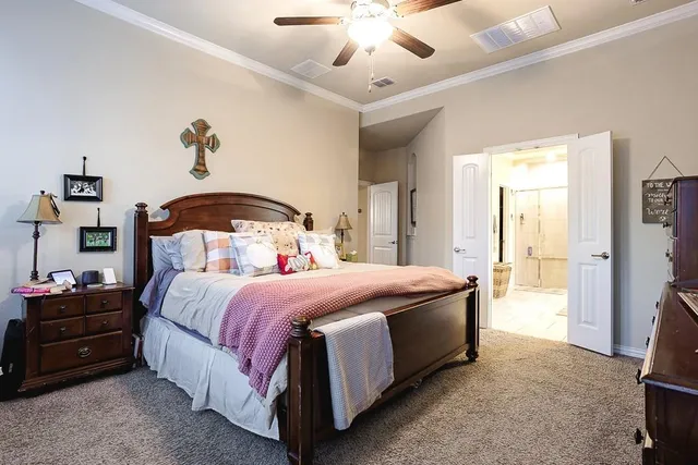 a bedroom with a bed and a chandelier