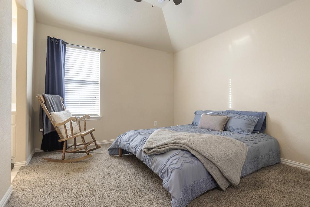 4505 Evenstar Way Plano, TX 75074 - Photo 23 of 29 Bedroom featuring light carpet, lofted ceiling, and ceiling fan