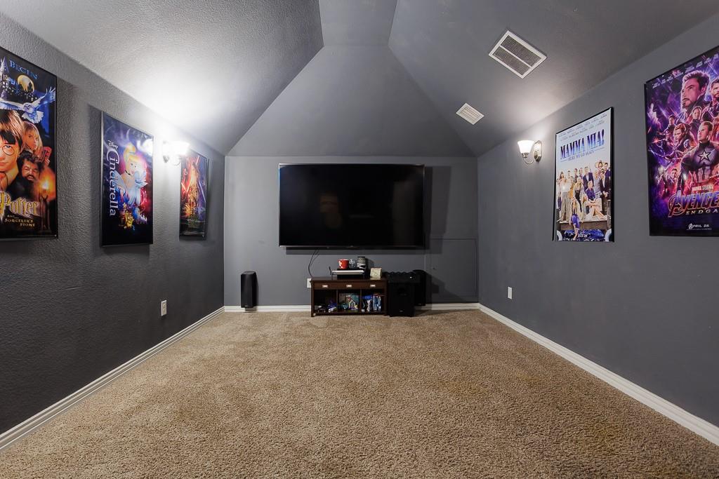 4505 Evenstar Way Plano, TX 75074 - Photo 24 of 29 Home theater with vaulted ceiling and carpet flooring