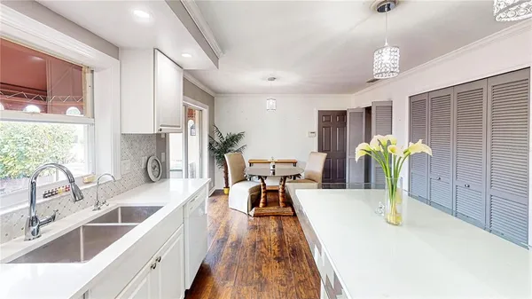 a view of a kitchen with sink and dining table