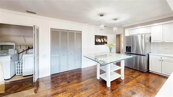 a kitchen with kitchen island a counter top space cabinets and stainless steel appliances